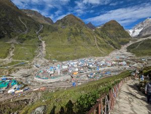 Snow-capped Kedarnath temple surrounded by Himalayan peaks in early morning light